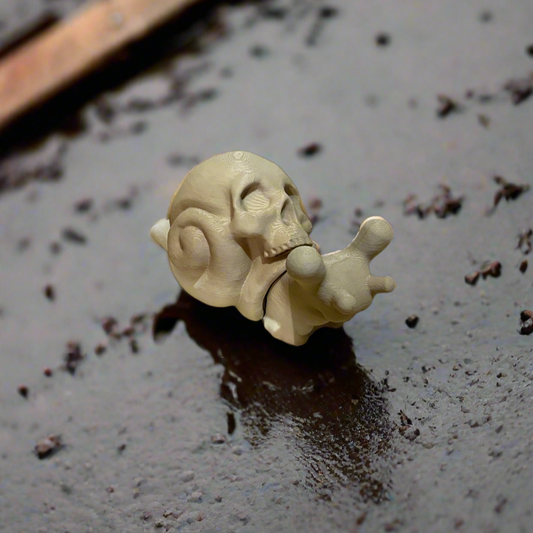 3D printed skull snail with a detailed skull shell in beige color.