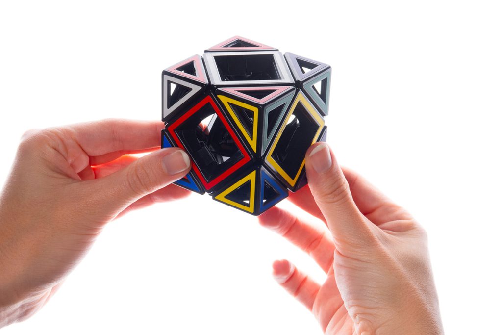 Hands holding a geometric puzzle